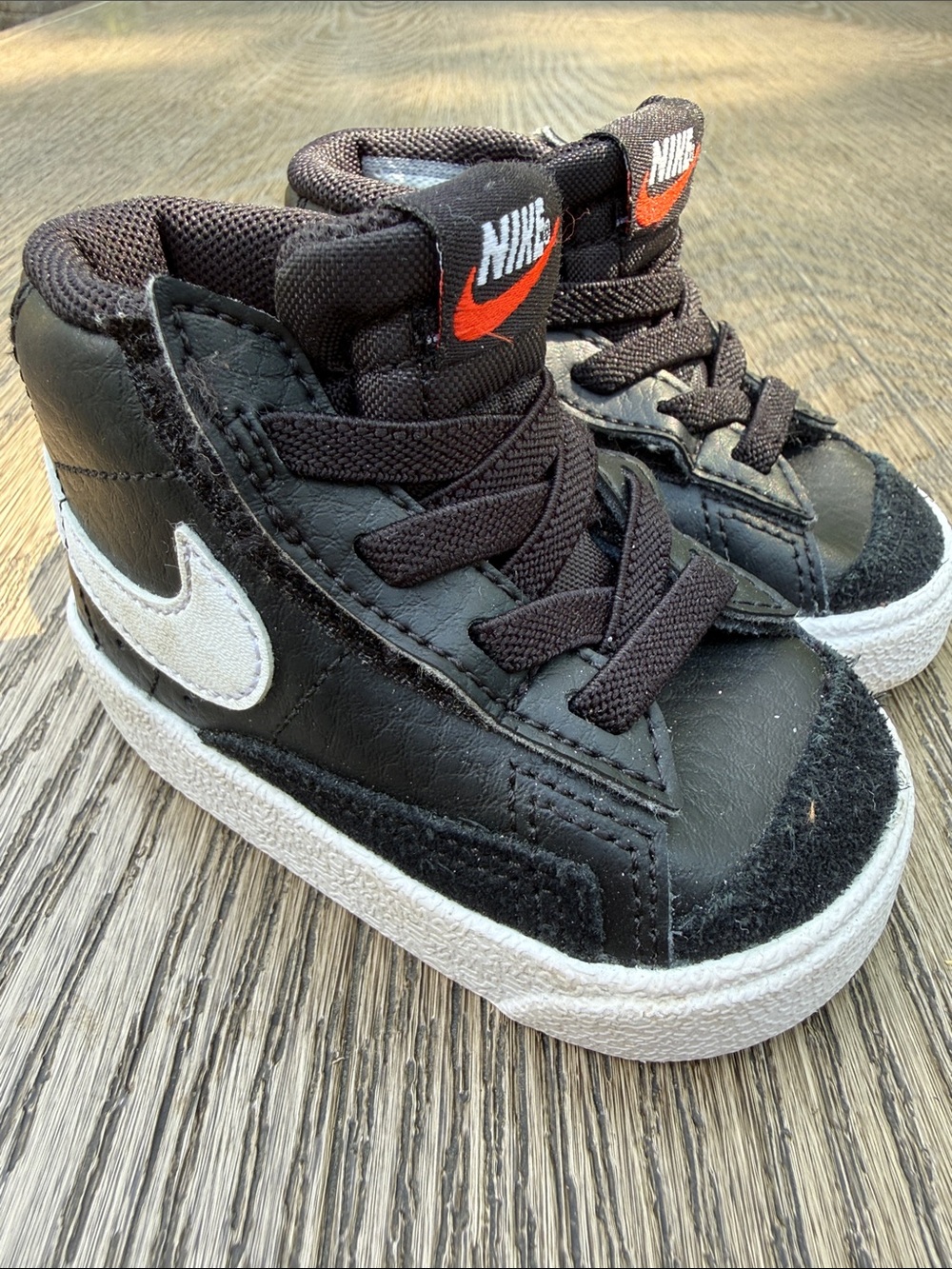 Nike Kids Black High-Top Sneakers with White Swoosh and Orange Logo